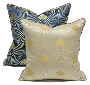 Close-up detail of luxury shell pattern decorative cushion covers with gold piping texture.