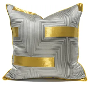 Detailed close-up view of the modern grey and gold geometric pattern decorative pillow cover.