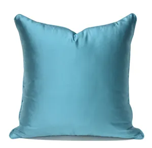 Close-up of blue satin pillow cover detail, smooth shiny texture for luxury home decor.