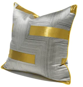 Modern geometric grey gold throw pillow detail view, luxurious sofa cushion cover design.