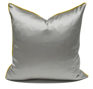 Grey satin throw pillow cover with vibrant yellow piping, modern square cushion for sofa.