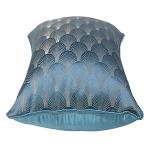 Blue velvet pillow cover detail showing elegant gold scallop pattern and zipper close-up view.