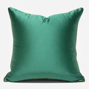 Elegant solid green satin square pillow cover with golden piping for modern luxury home decor.