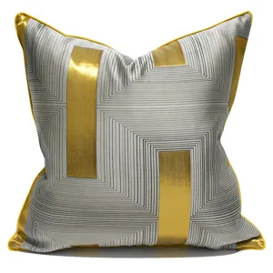 Modern luxury grey and gold geometric throw pillow cover with yellow piping for sofa decor.
