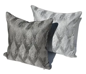 Vista dettagliata di cuscini grigio scuro moderni con elegante motivo geometrico testurizzato.