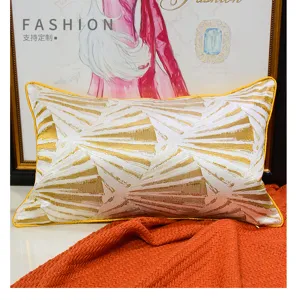 Detailed view of luxury yellow fan pattern decorative throw pillow with gold embroidery.