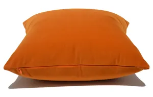 Vista dettagliata di una lussuosa federa per cuscino in velluto arancione con zip.