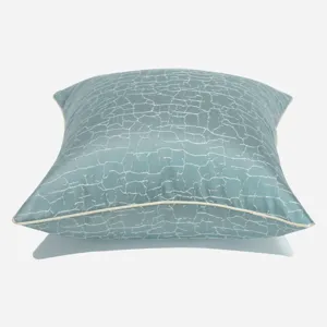 Modern Nordic blue-green throw pillow cover with white piping and crackle pattern cushion.