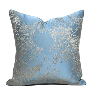Exquisite jacquard throw pillow cover detail, light blue fabric with elegant silver botanical pattern.