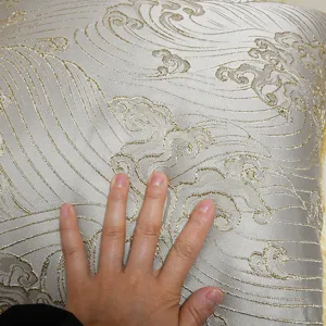 Luxury jacquard sofa cushion cover detail, gold wave pattern, high precision fabric texture.