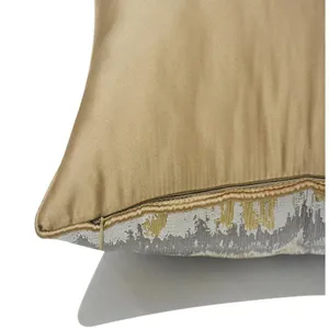 Detail view of modern luxury gold cushion cover, exquisite textured fabric with smooth finish.
