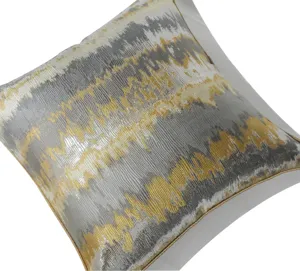 Modern luxury throw pillow cover with gold and gray abstract wave geometric pattern for sofa.