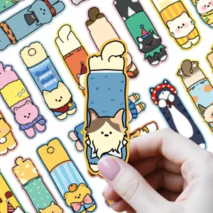 Close-up detail of cute cartoon animal shape paper bookmarks featuring lovely cats and dogs.