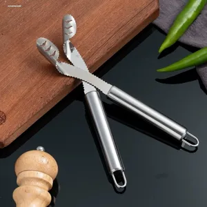 Stainless steel chili pepper corer kitchen tool for seeding and coring green peppers.