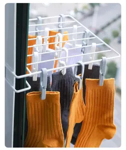 Window hanging drying rack detail, plastic laundry clip close up, compact balcony sock drying stand.