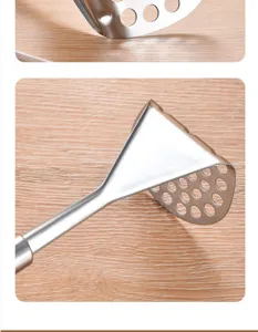 Stainless steel potato masher detail view showing the durable triangle press plate with clean holes.