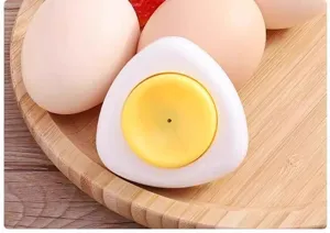 Closeup of magnetic egg piercer with spring loaded needle for kitchen cooking and boiling eggs securely.