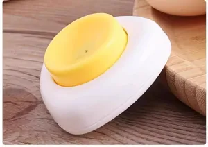 Detail view of a cute fried egg shaped kitchen egg piercer tool for easy boiling and anti-burst.