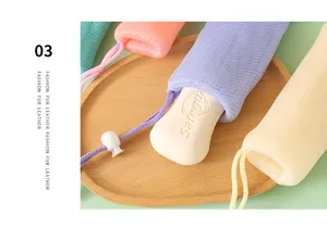 Colorful mesh soap pouch foaming net bag with drawstring and soap bar for daily body cleansing.