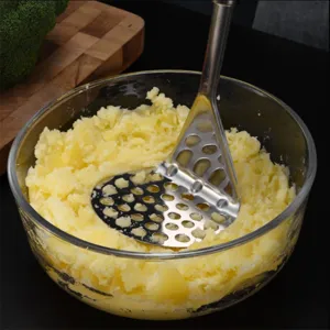 Stainless steel potato masher kitchen tool for easily mashing sweet potatoes.