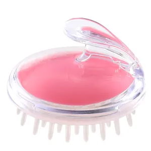 Clear plastic scalp massage brush with pink core and ergonomic handle for hair washing daily.
