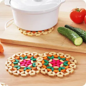 Handmade wooden beaded heat resistant trivet mat for hot pots, dishes and bowls on dining table.