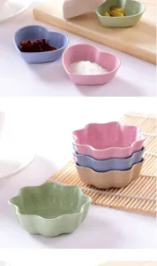 Close-up of cute heart and flower shaped wheat straw condiment bowls, ideal for soy sauce or snacks.