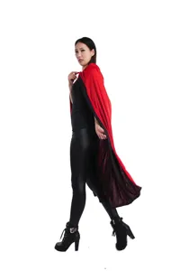 Detail view of the red and black reversible hooded cloak, showing length and double-layer style.