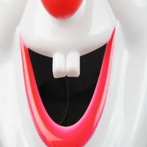 Close-up detail of the plastic clown mask showing the distinctive red nose and front teeth.