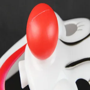 Clown party mask detail shot, featuring a bright red round nose and cute white cartoon design.