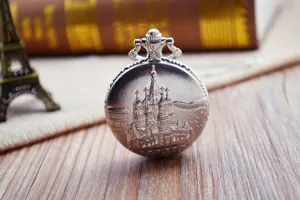 Vintage silver quartz pocket watch featuring a detailed cathedral embossed retro design.