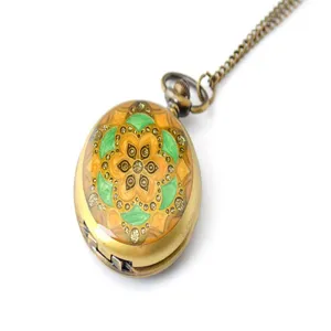 Vintage bronze pocket watch with colorful enamel floral pattern and rhinestones on chain.