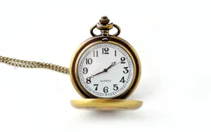 Vintage bronze pocket watch detail shot, classic white dial with clear numbers and chain.