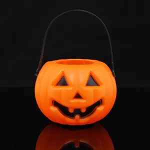 Close-up detail view of the Halloween pumpkin candy bucket with black handle and classic carved face.