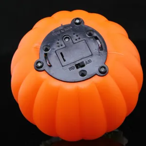 Bottom detail view of Halloween pumpkin LED light with battery compartment and switch.