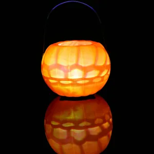 Halloween glowing pumpkin bucket candy container with metal handle for holiday party decor.