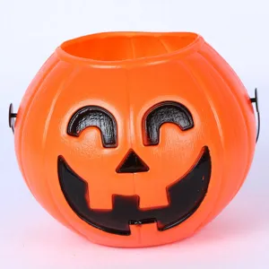 Halloween plastic pumpkin bucket detail, orange jack-o-lantern candy container for party.