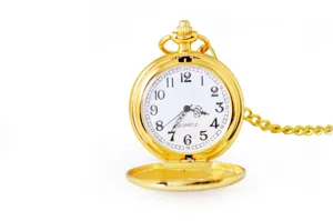 Gold pocket watch detail showing white quartz dial with clear Arabic numerals and metal chain.