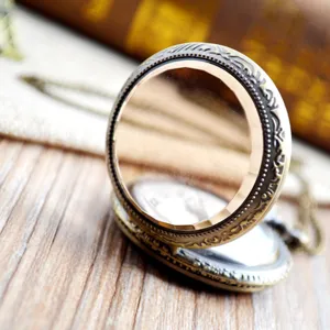 Vintage pocket watch featuring brown transparent glass cover and bronze carved case styling.