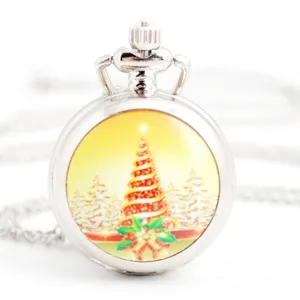 Closeup of a vintage silver necklace pocket watch featuring a festive Christmas tree dial design.