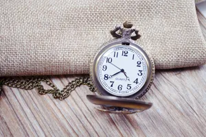 Vintage bronze quartz pocket watch with long chain, classic carved design for daily.