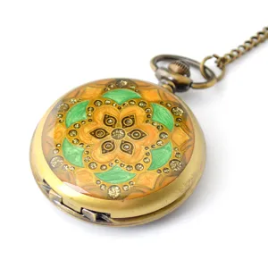 Vintage bronze pocket watch with retro enameled floral pattern and sweater chain.