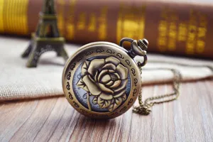 Vintage bronze pocket watch featuring a carved rose design, antique style with chain necklace.