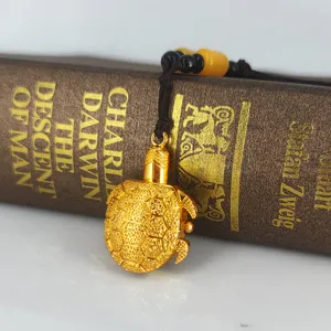 Close up of exquisite gold turtle pendant watch with black cord and detailed beads display.