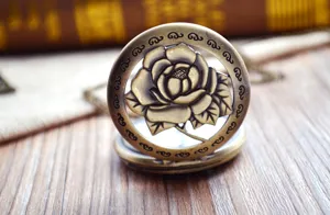 Vintage bronze hollow rose pocket watch with chain, classic retro floral carved design.