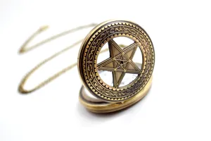 Detailed view of a vintage bronze hollow pentagram quartz pocket watch with chain for unisex.