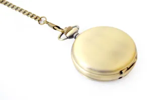 Detailed view of vintage bronze mechanical pocket watch with matching chain, close-up shot.