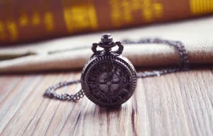Vintage bronze tone hollow pocket watch quartz close up dial chain detailed macro view