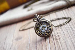 Detailed view of bronze skeleton pocket watch with vintage gear design and chain.