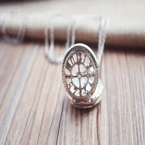 Close-up detail of vintage silver hollow pocket watch dial with intricate gear design.